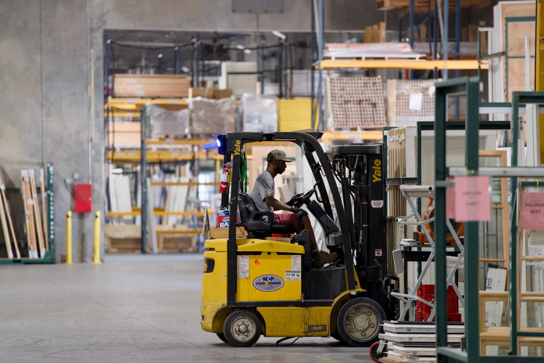 A Tucker forklift operator moving door units through the warehouse
