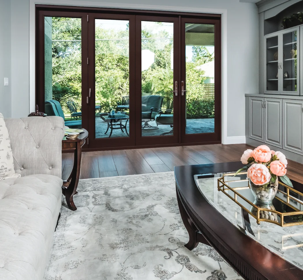 A mahogany folding glass door opening a living room onto a patio
