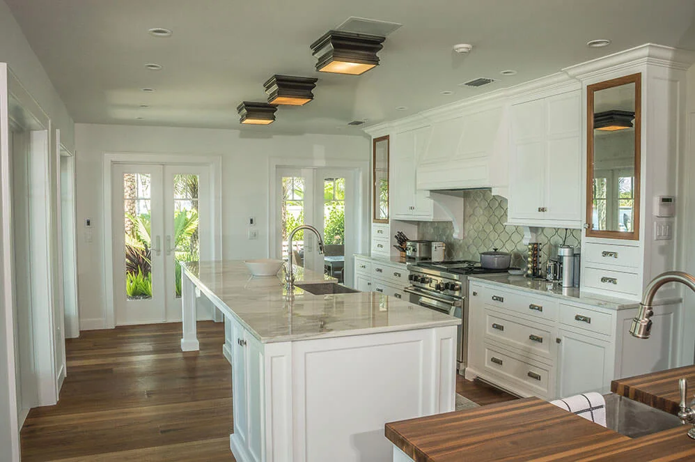 A pair of white Neuma french doors flanking a kitchen