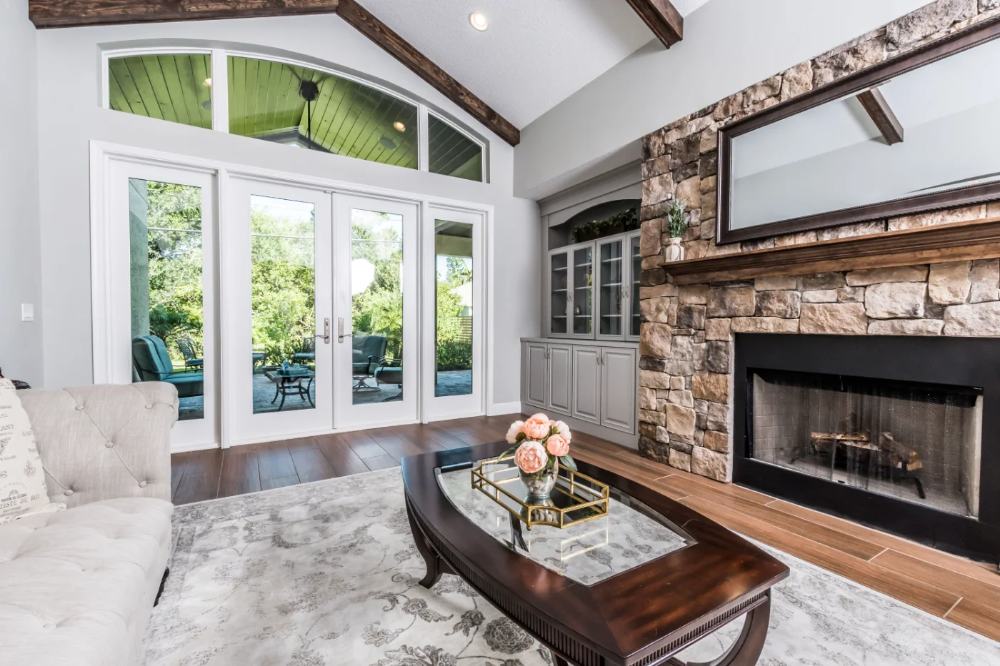 White Neuma french doors with sidelites and an arched transom in a living room