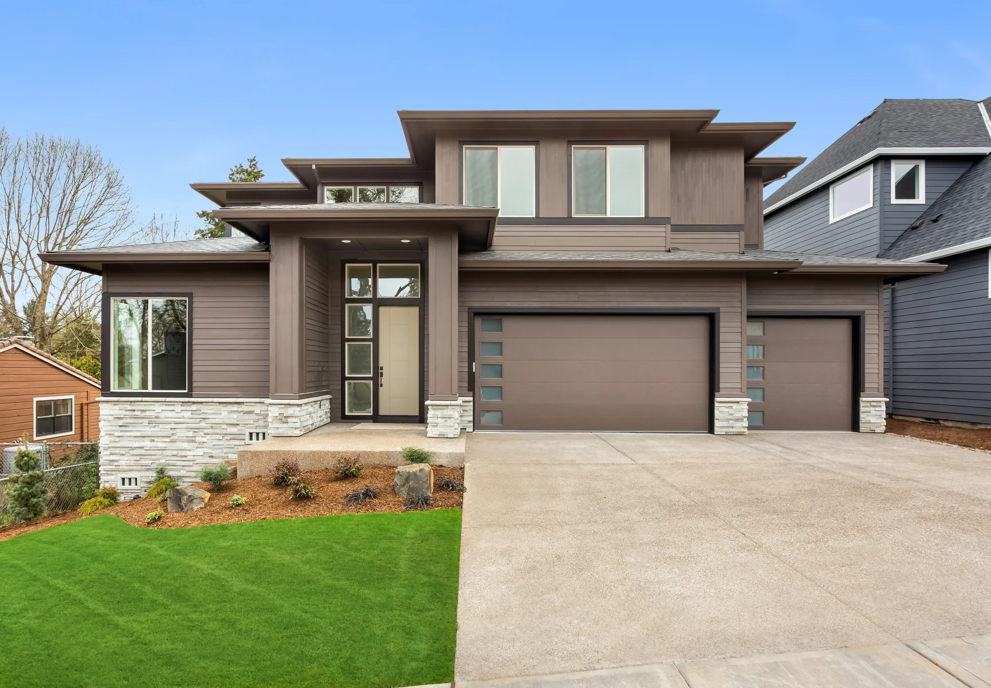 Plastpro entry door with tall sidelites on a prairie-style home