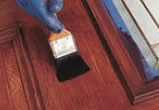Stain brushed onto a woodgrain fiberglass door panel