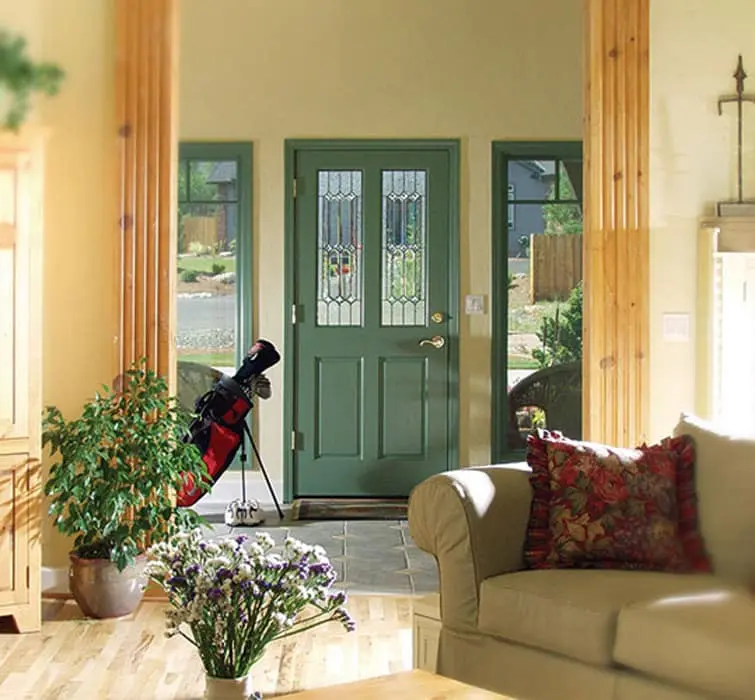 A green painted Rogue Valley Door entry with leaded glass lites, seen from inside the room