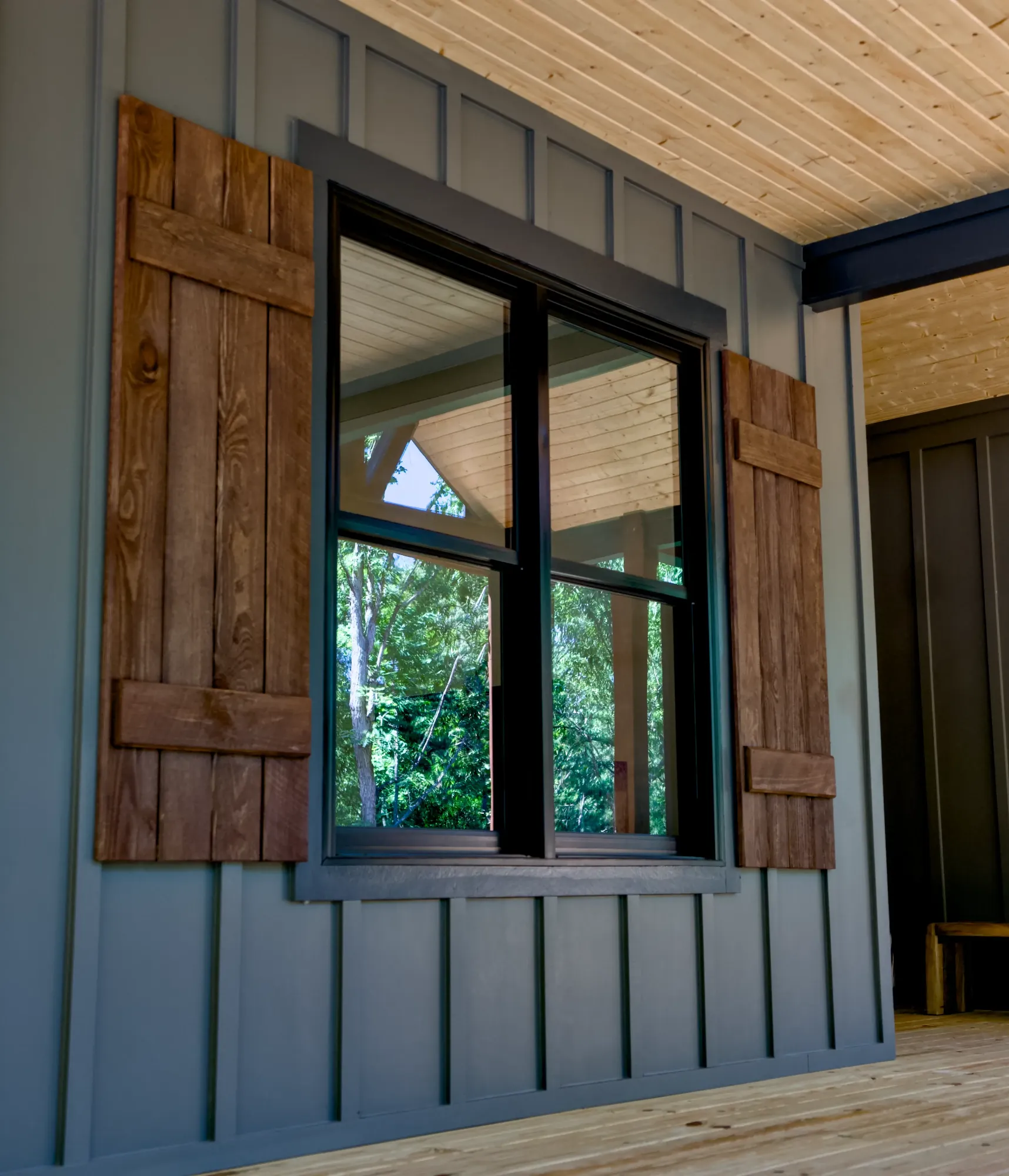 Exterior window with board shutters on a finished home