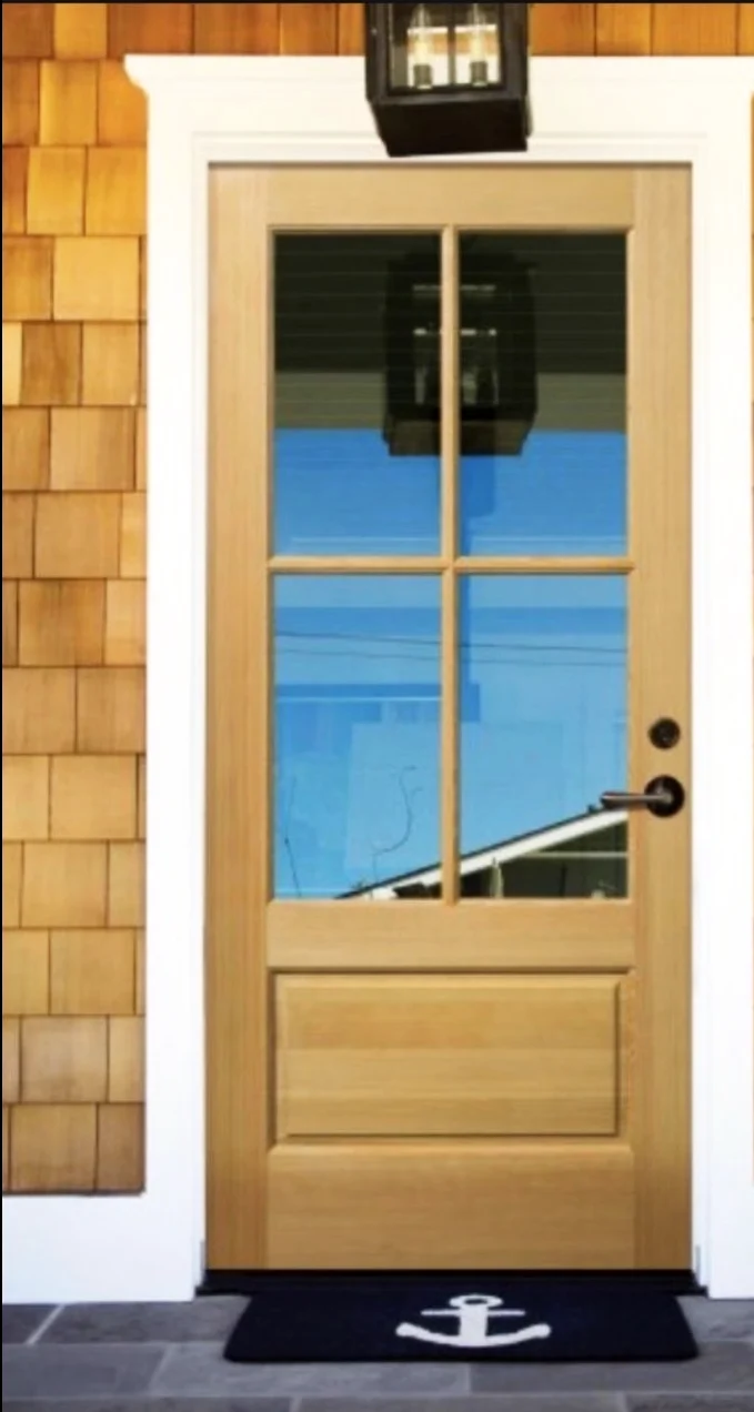 Wood entry with divided lites on a shingle house