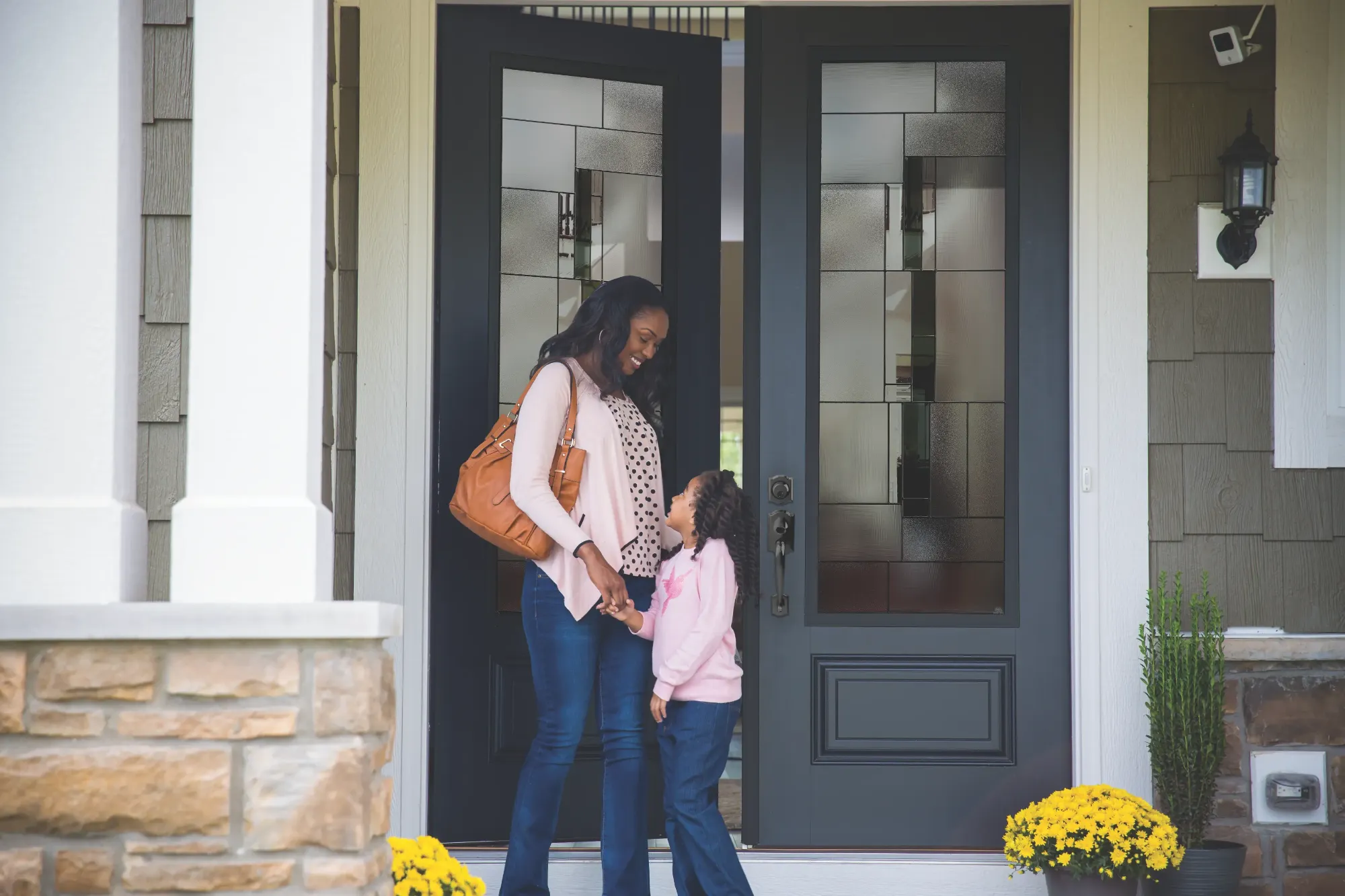 A mother and daughter at a Masonite double entry door