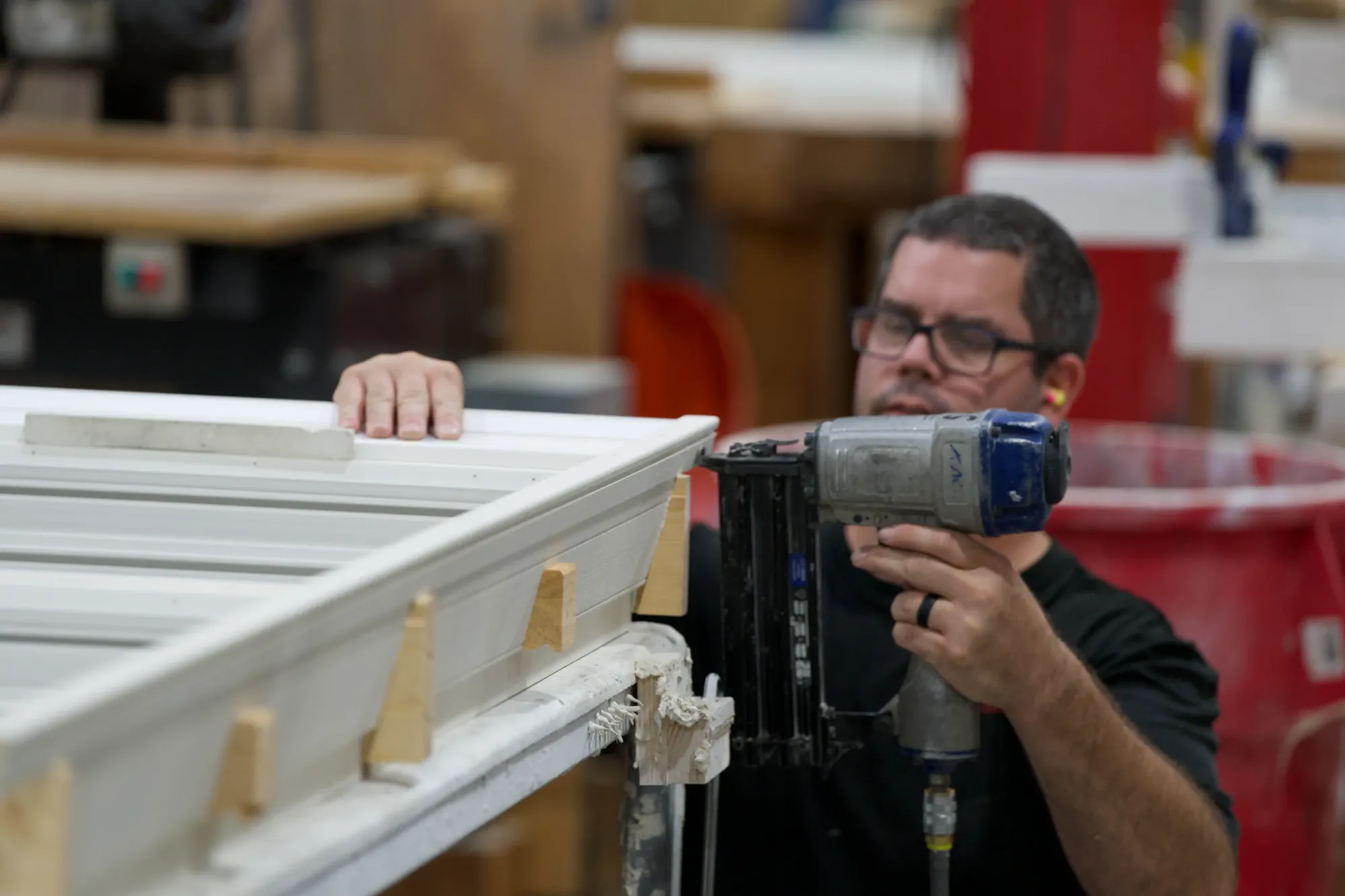A Tucker fabricator nailing a prehung door frame together on the bench