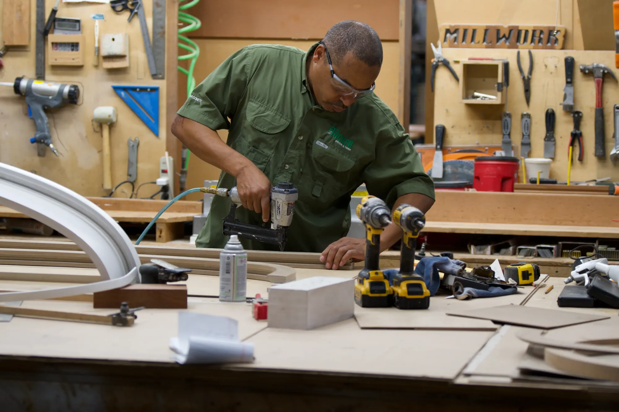 A Tucker Door & Trim craftsman assembling millwork in the Monroe shop