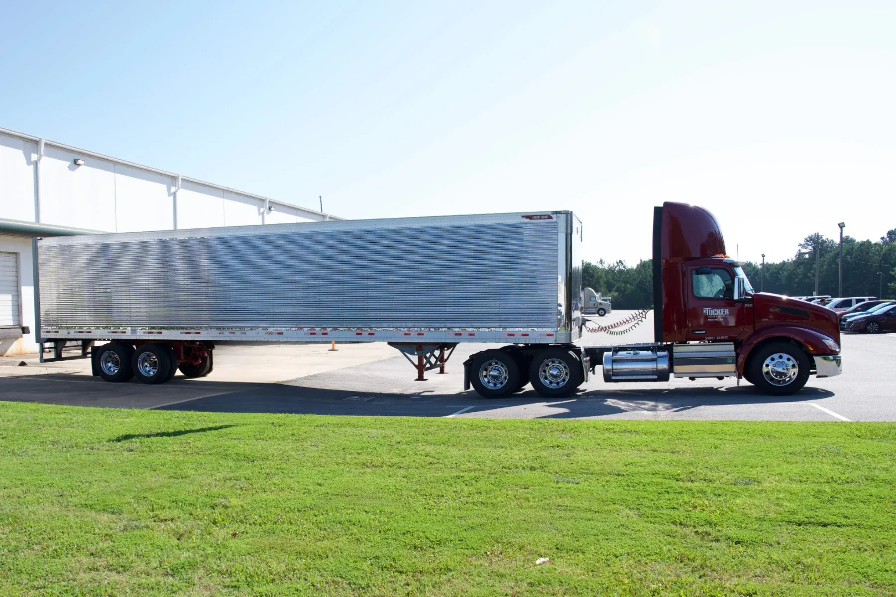 A Tucker Door & Trim tractor and trailer parked at the Monroe dock