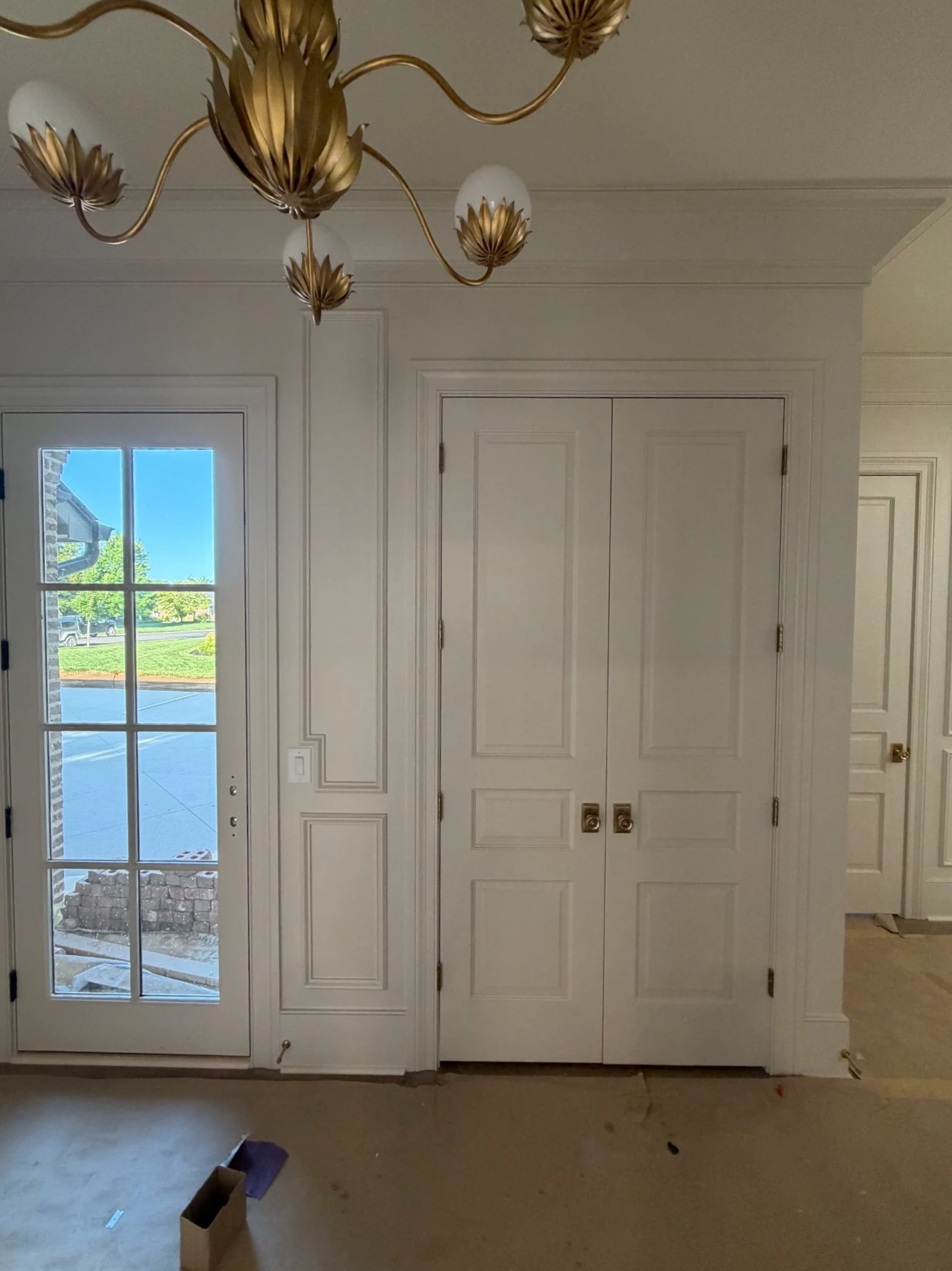 Painted double doors with full height casing and crown in a new entry