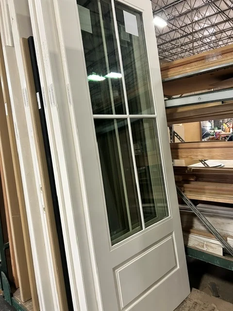 A putty finished door with SDL bars standing in the Monroe shop