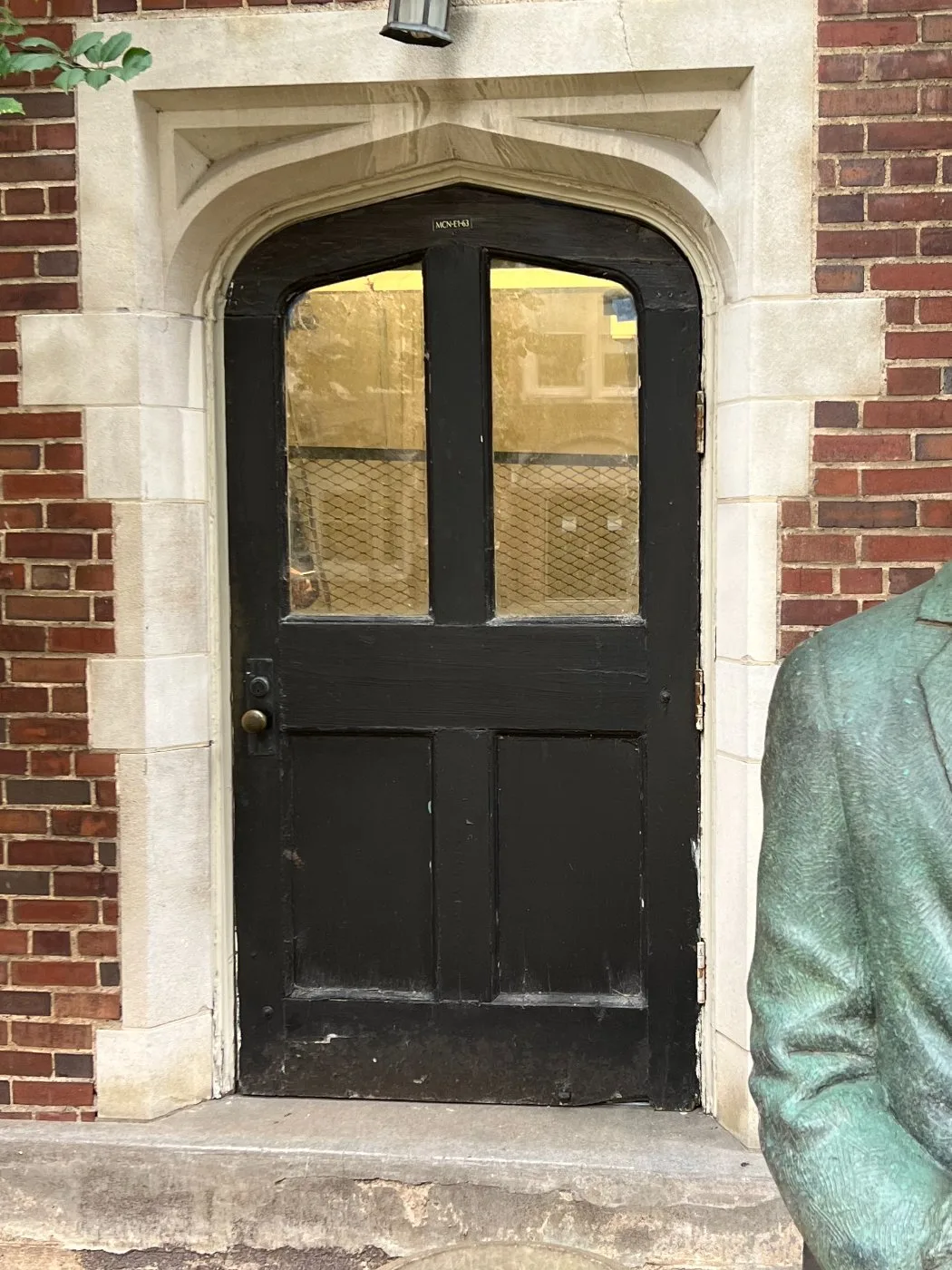 The original black painted arched entry door before the change out