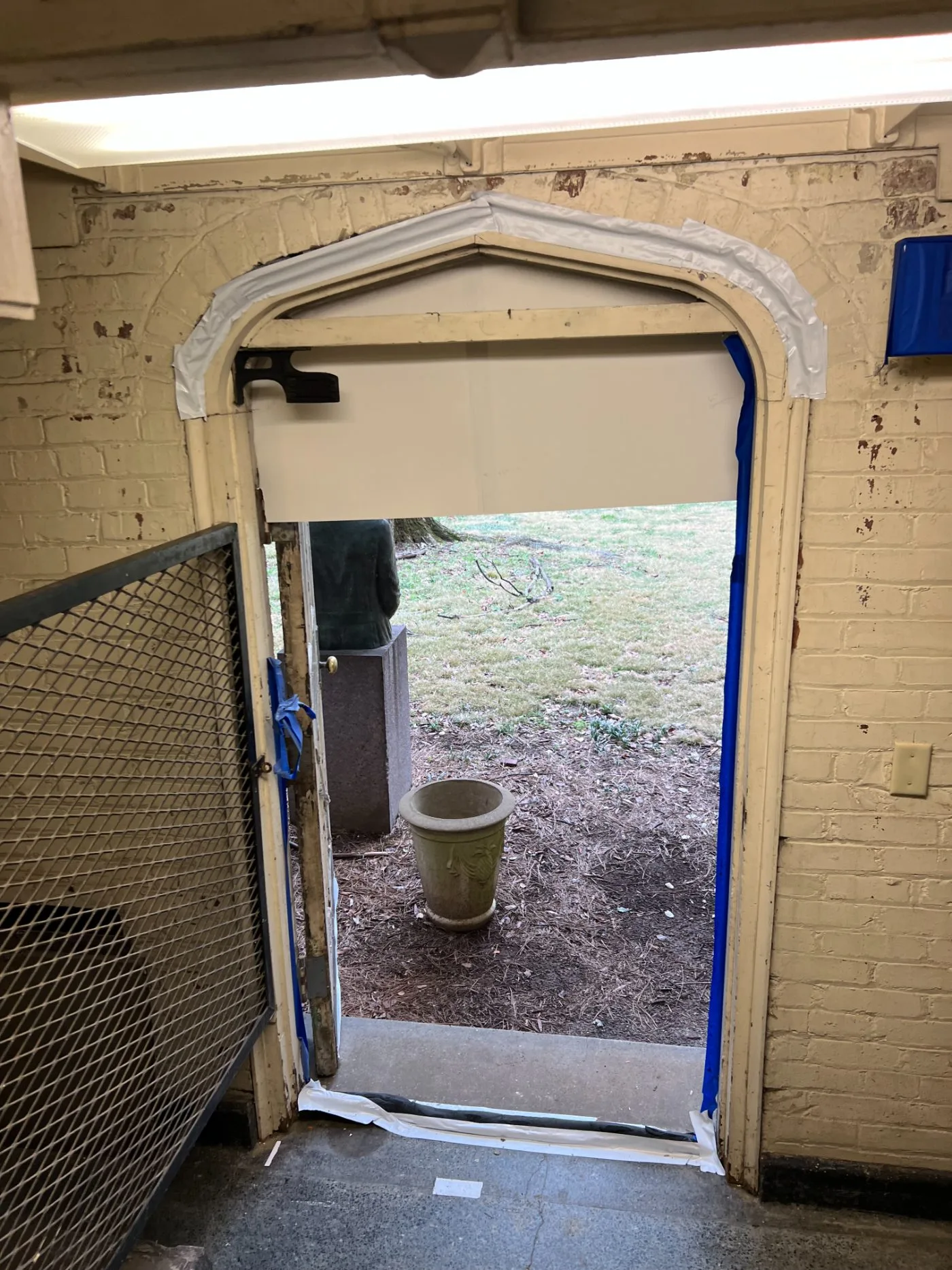 Arched masonry opening masked off with the door removed
