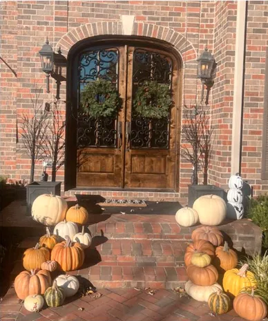 The finished knotty alder arched entry installed in a brick elevation